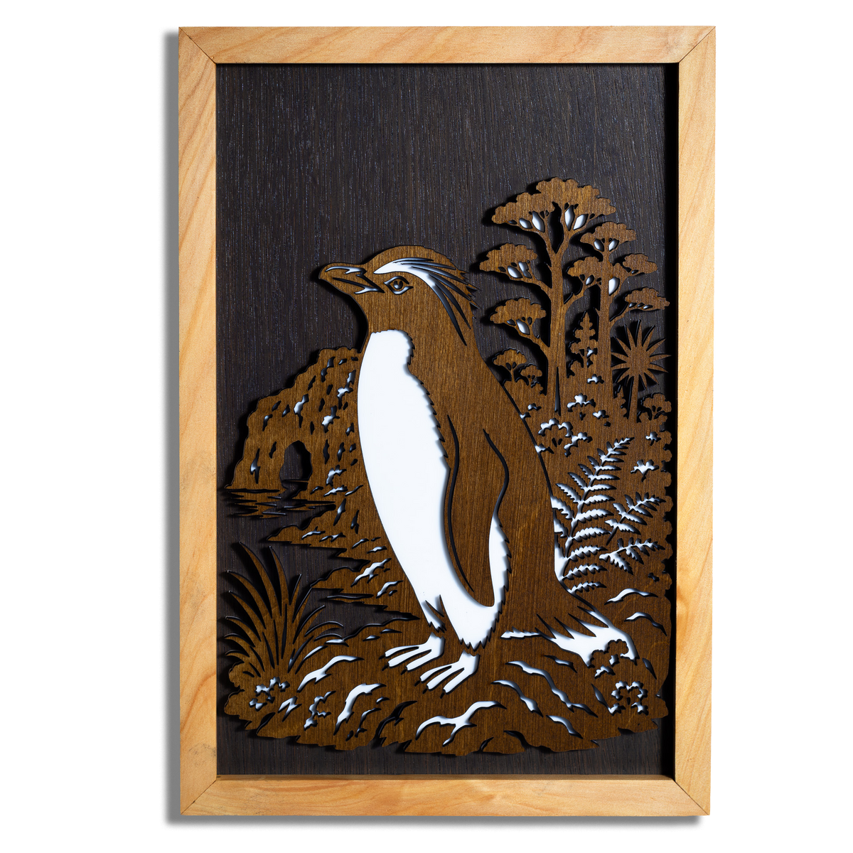 Tawaki Fiordland penguin layered timber wall art in a macrocarpa frame, front view
