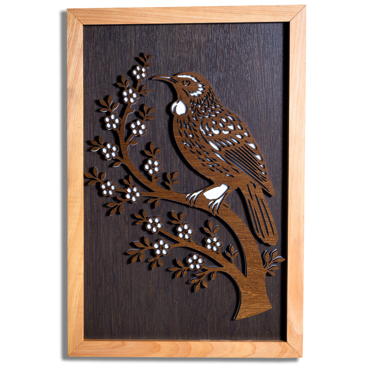 Tūī layered timber wall art in a macrocarpa frame, front view