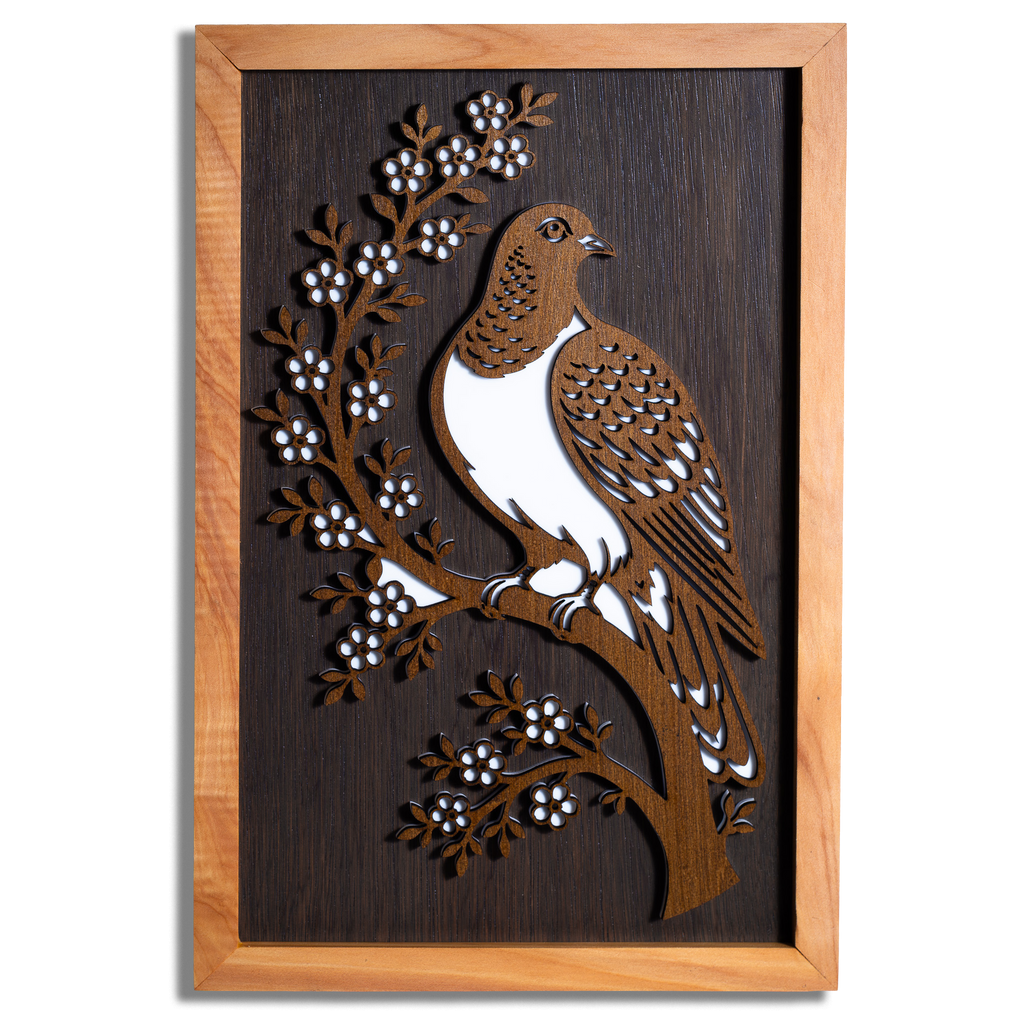 Kererū layered timber wall art in a macrocarpa frame, front view